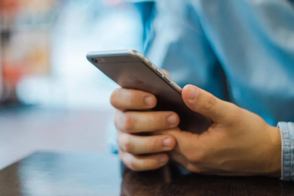 A hand holding an iPhone